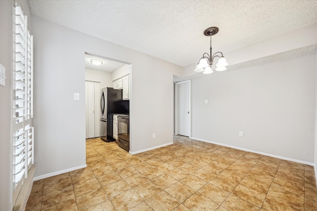 interior space with light tile patterned flooring, a textured ceiling, a chandelier, and baseboards