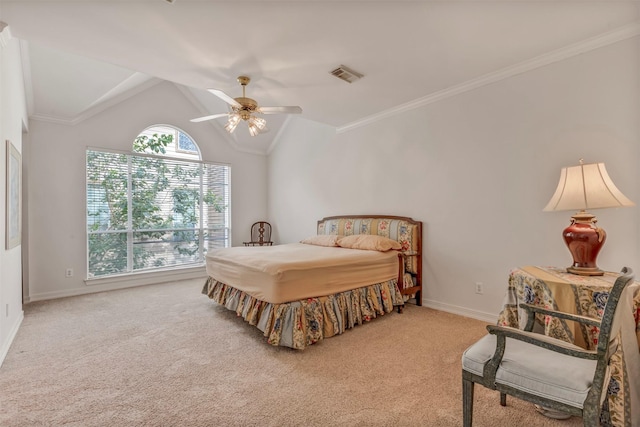 carpeted bedroom featuring visible vents, crown molding, baseboards, a ceiling fan, and vaulted ceiling