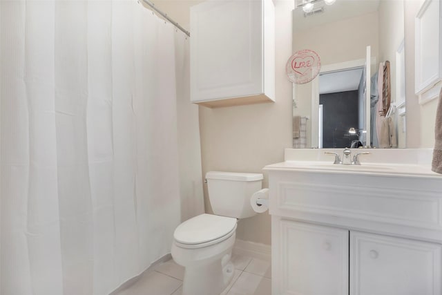 bathroom featuring vanity, toilet, tile patterned floors, baseboards, and visible vents