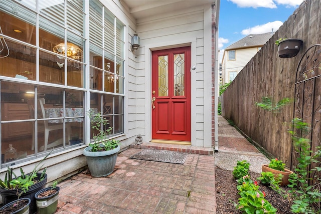 doorway to property featuring fence