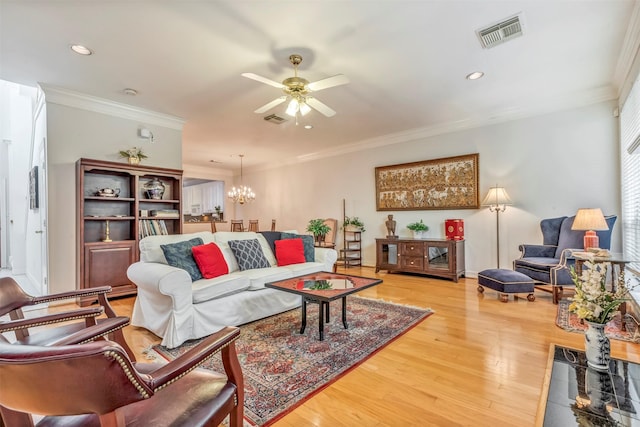 1202 Joe Annie St, Houston, TX 77019 - living area featuring visible vents, ornamental molding, ceiling fan with notable chandelier, and light wood-style floors
