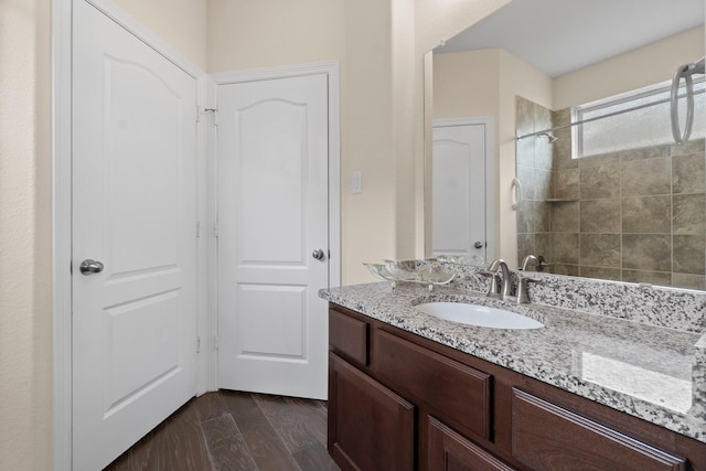 full bathroom with wood finished floors and vanity
