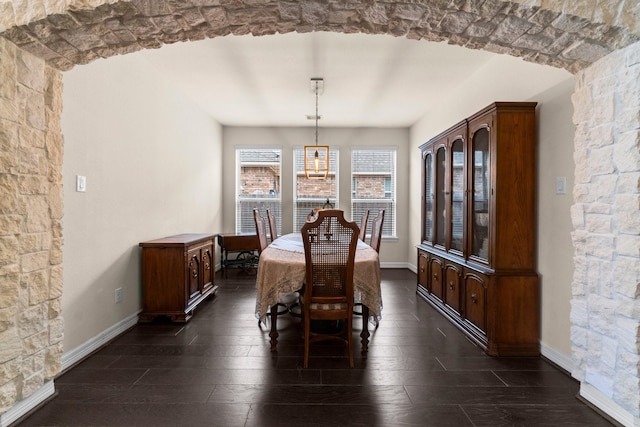 dining area featuring baseboards and dark wood-style floors