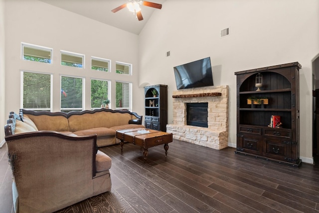 living area featuring visible vents, wood finished floors, a fireplace, high vaulted ceiling, and a ceiling fan