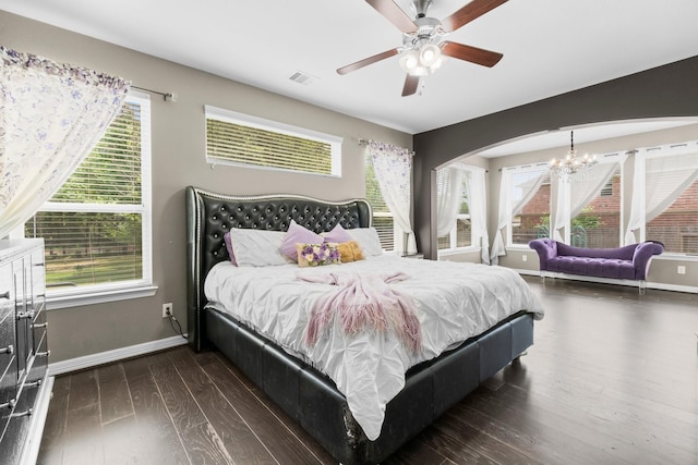 bedroom featuring visible vents, dark wood-style flooring, and multiple windows