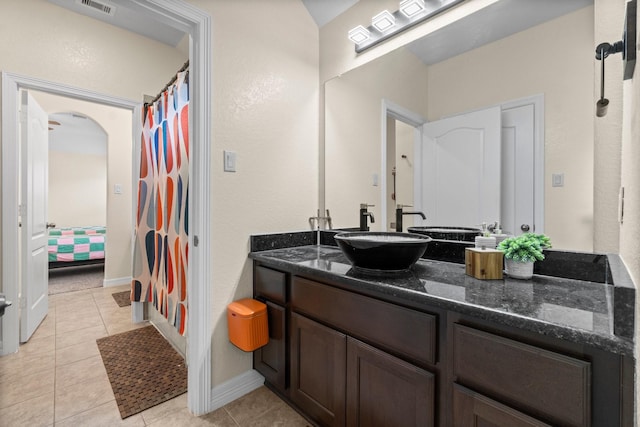 full bathroom featuring tile patterned flooring, baseboards, visible vents, and vanity