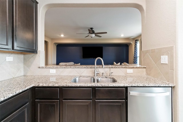 kitchen featuring decorative backsplash, dark brown cabinetry, a ceiling fan, dishwasher, and a sink