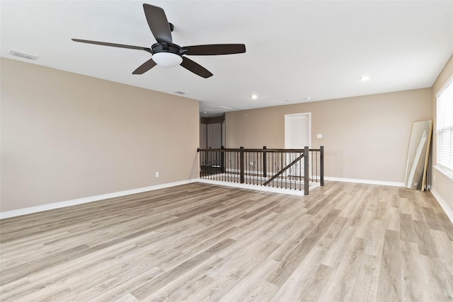 spare room featuring ceiling fan, light wood-style floors, recessed lighting, baseboards, and visible vents
