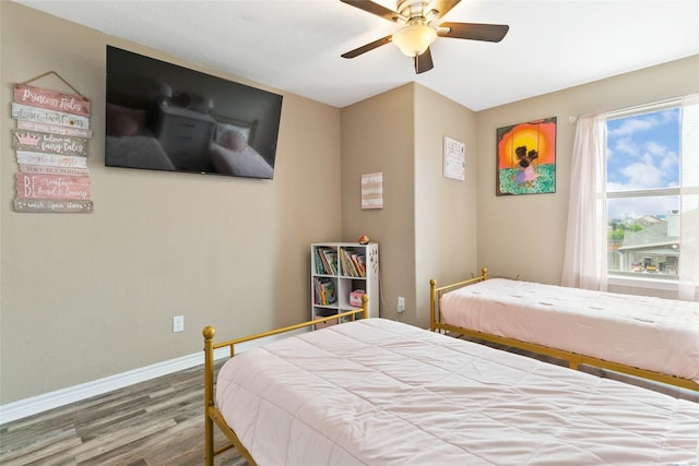 bedroom featuring baseboards, ceiling fan, and wood finished floors