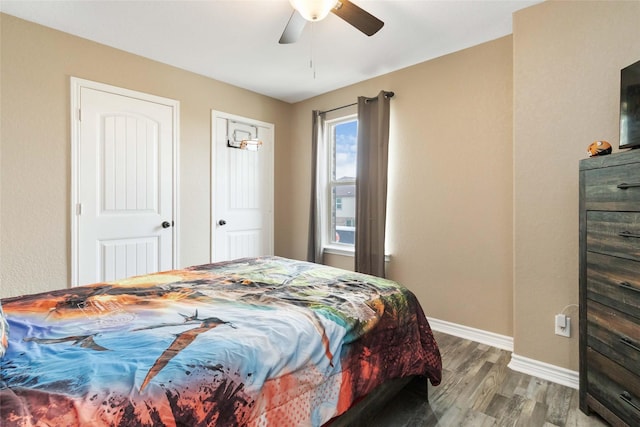 bedroom featuring baseboards, a ceiling fan, and wood finished floors