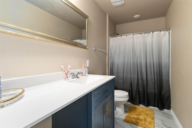 bathroom with vanity, marble finish floor, a textured wall, and toilet