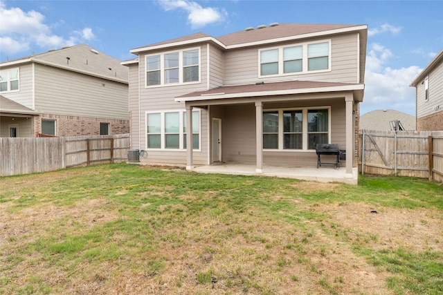 rear view of house featuring a fenced backyard, a patio, a lawn, and cooling unit