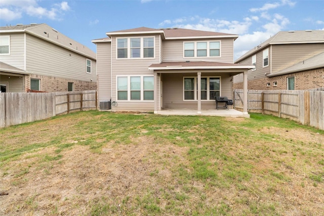 rear view of property featuring a patio, a fenced backyard, a yard, and cooling unit