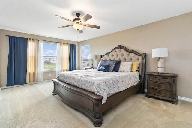 carpeted bedroom with a ceiling fan and baseboards