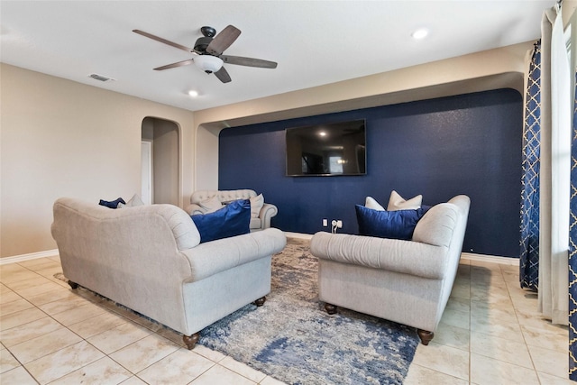 tiled living area featuring ceiling fan, arched walkways, recessed lighting, baseboards, and visible vents