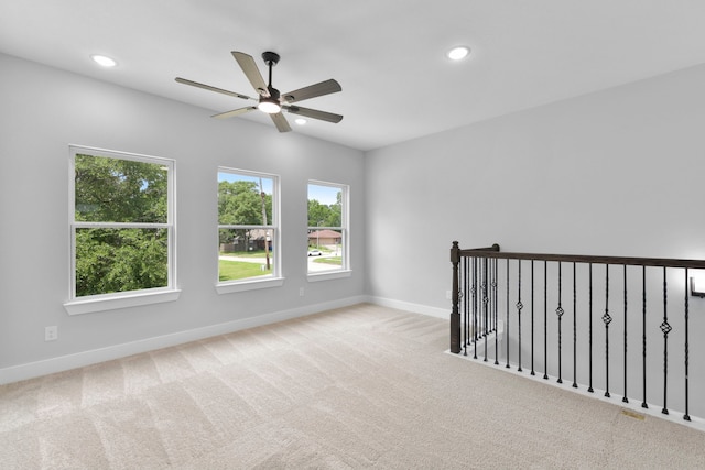 carpeted empty room featuring recessed lighting, a ceiling fan, and baseboards