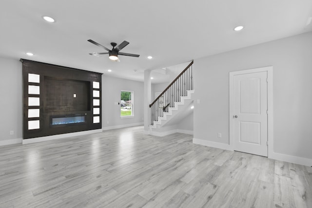 foyer featuring a ceiling fan, wood finished floors, stairway, baseboards, and recessed lighting