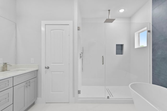 full bathroom with a shower stall, a soaking tub, and vanity