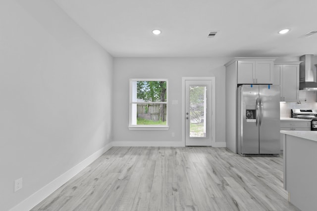 kitchen with visible vents, recessed lighting, light countertops, wall chimney exhaust hood, and stainless steel appliances
