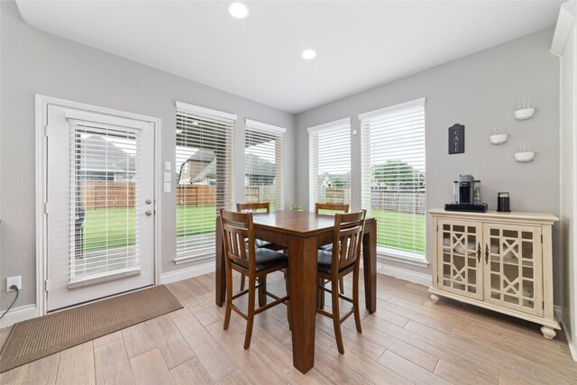 dining room with light wood-style floors, baseboards, and recessed lighting