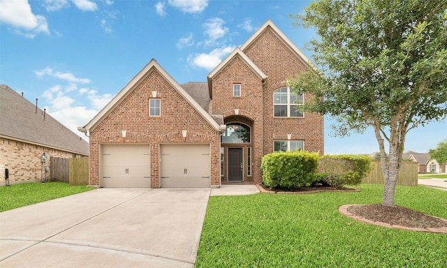 traditional home with fence, driveway, a front lawn, and brick siding