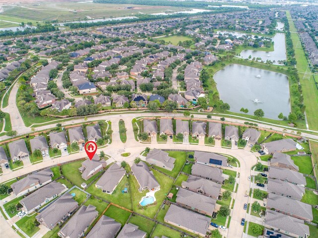 drone / aerial view with a residential view and a water view