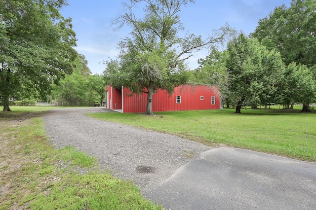 view of pole building with a lawn and driveway