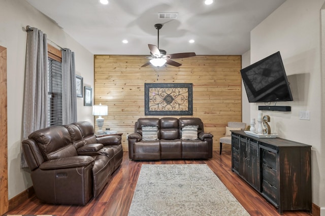 living area featuring visible vents, wood walls, ceiling fan, recessed lighting, and dark wood-type flooring
