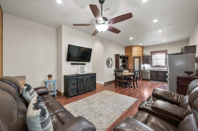 living room with ceiling fan, dark wood-style flooring, recessed lighting, and visible vents