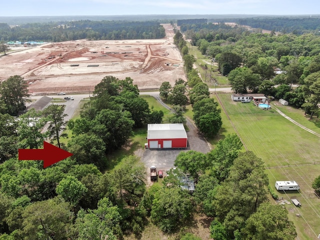 birds eye view of property featuring a wooded view