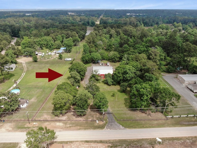 bird's eye view with a wooded view