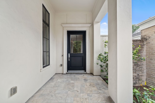 property entrance with stucco siding