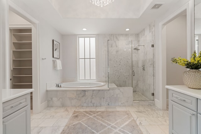 bathroom with a stall shower, visible vents, marble finish floor, and vanity