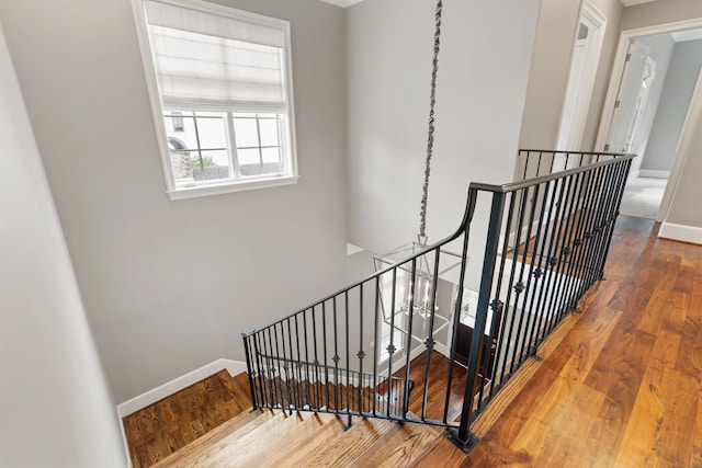 stairs featuring baseboards and hardwood / wood-style floors