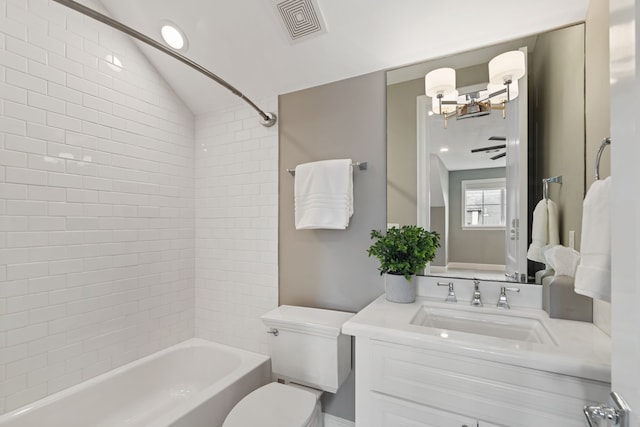 full bath with visible vents, vanity, toilet, vaulted ceiling, and shower / washtub combination