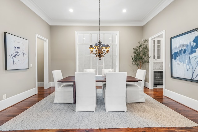 dining area with dark wood-style flooring, baseboards, a notable chandelier, ornamental molding, and recessed lighting