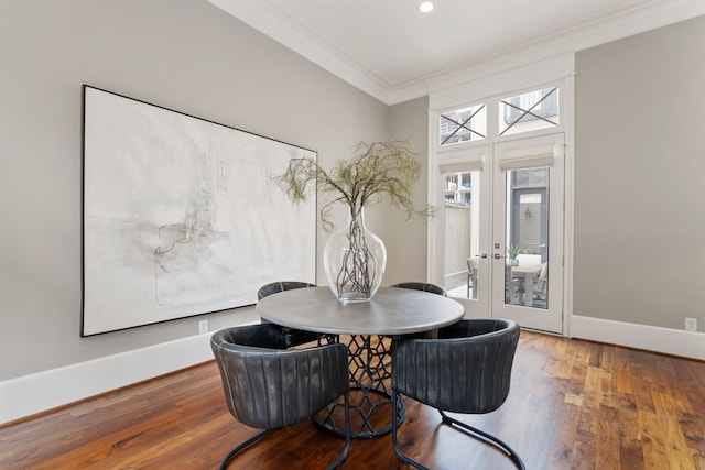 dining area with crown molding, baseboards, french doors, and wood finished floors
