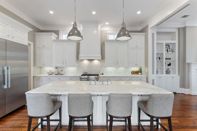 kitchen featuring stove, a sink, custom exhaust hood, ornamental molding, and stainless steel built in refrigerator