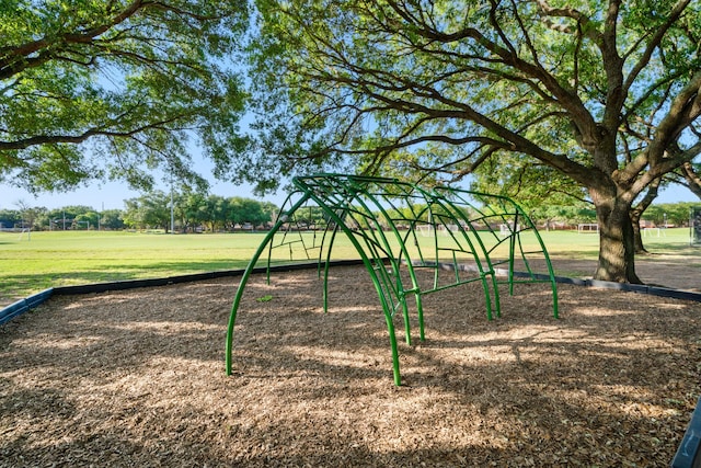 community jungle gym featuring a lawn