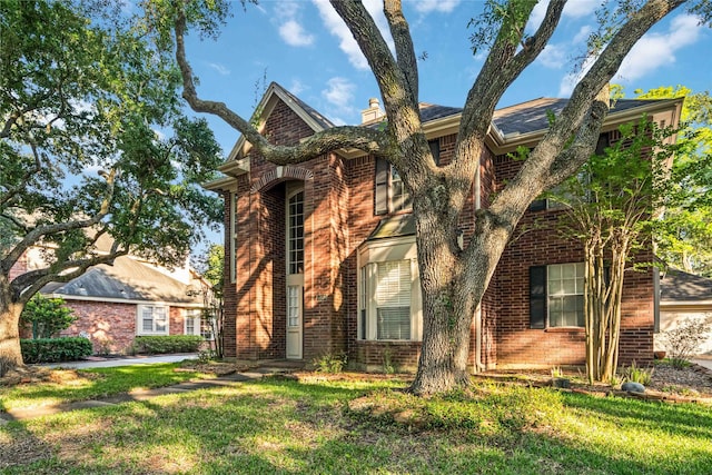 5818 Wilkins Ln, Sugar Land, TX 77479 - view of front of home featuring brick siding, a front yard, and a chimney