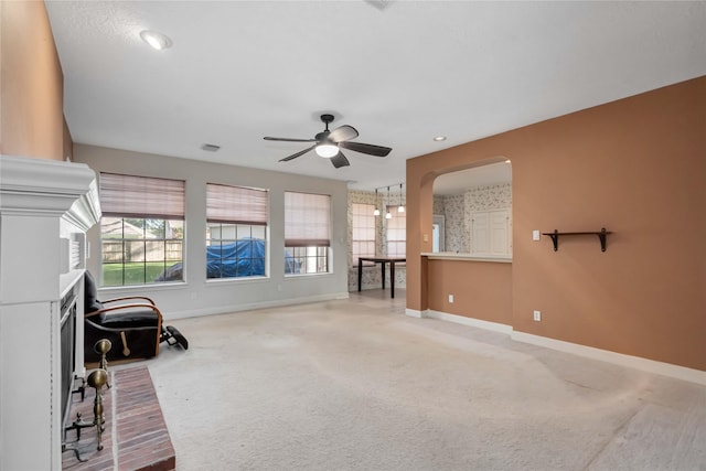 sitting room with baseboards, ceiling fan, carpet floors, arched walkways, and recessed lighting