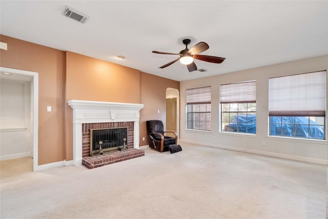 unfurnished living room featuring a brick fireplace, healthy amount of natural light, and baseboards