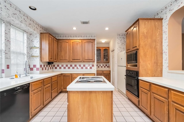 5818 Wilkins Ln, Sugar Land, TX 77479 - kitchen featuring black appliances, wallpapered walls, a sink, arched walkways, and a center island