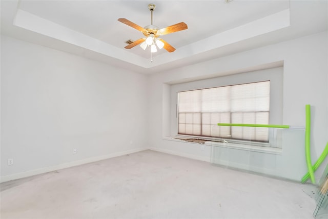 5818 Wilkins Ln, Sugar Land, TX 77479 - spare room with a raised ceiling, baseboards, carpet floors, and a ceiling fan