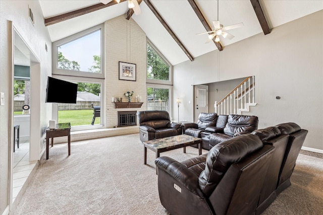 living room with a ceiling fan, high vaulted ceiling, beam ceiling, and carpet