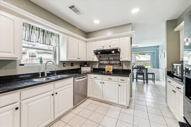 kitchen featuring white cabinets, a sink, dishwasher, under cabinet range hood, and visible vents