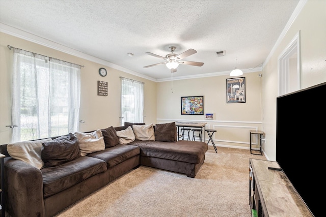 living room featuring a ceiling fan, light colored carpet, visible vents, and ornamental molding