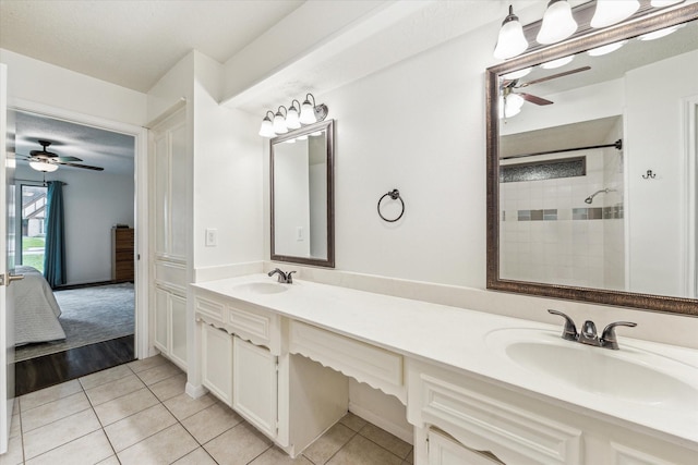 ensuite bathroom with tile patterned flooring, a sink, and ceiling fan