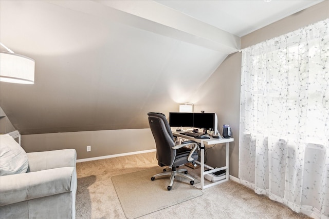 carpeted home office featuring baseboards and vaulted ceiling