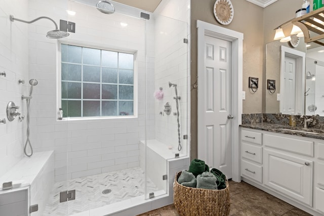 full bath featuring vanity, tile patterned flooring, and tiled shower